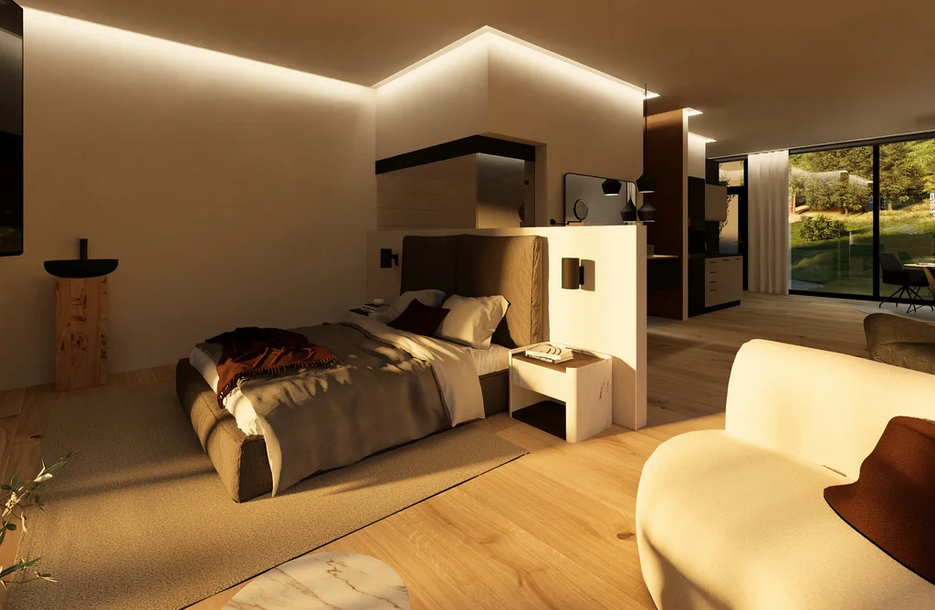 Modernes Hotelzimmer mit Doppelbett, Sessel und großer Fensterfront mit Blick ins Grüne