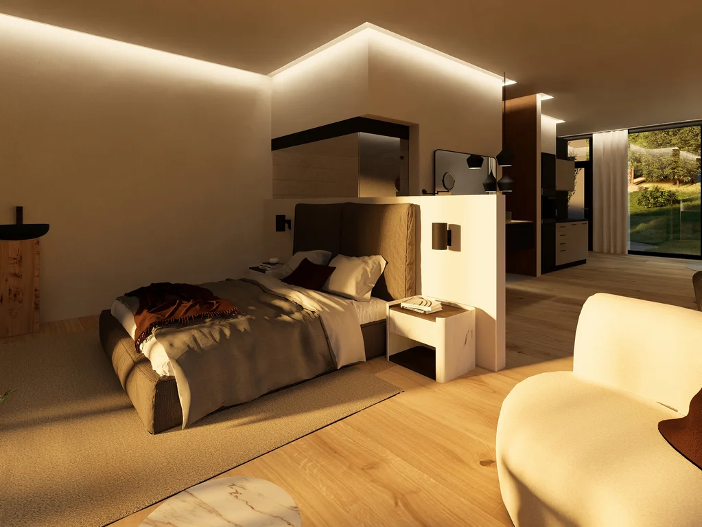 Modernes Hotelzimmer mit Doppelbett, Sessel und großer Fensterfront mit Blick ins Grüne
