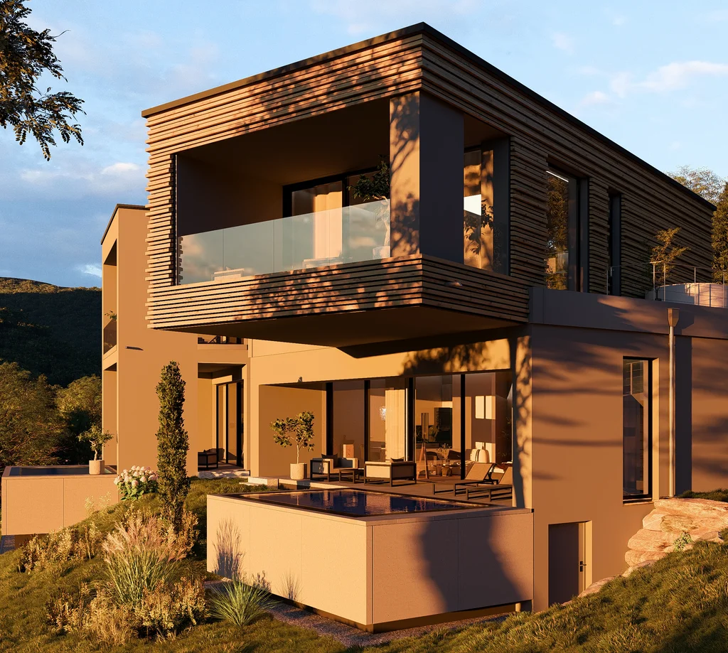 Modernes Haus mit Holzverkleidung und Terrasse in grüner Landschaft bei Sonnenuntergang